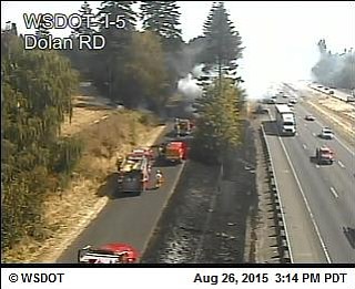 Firefighters respond to a brush fire along Interstate 5 south of Ridgefield.