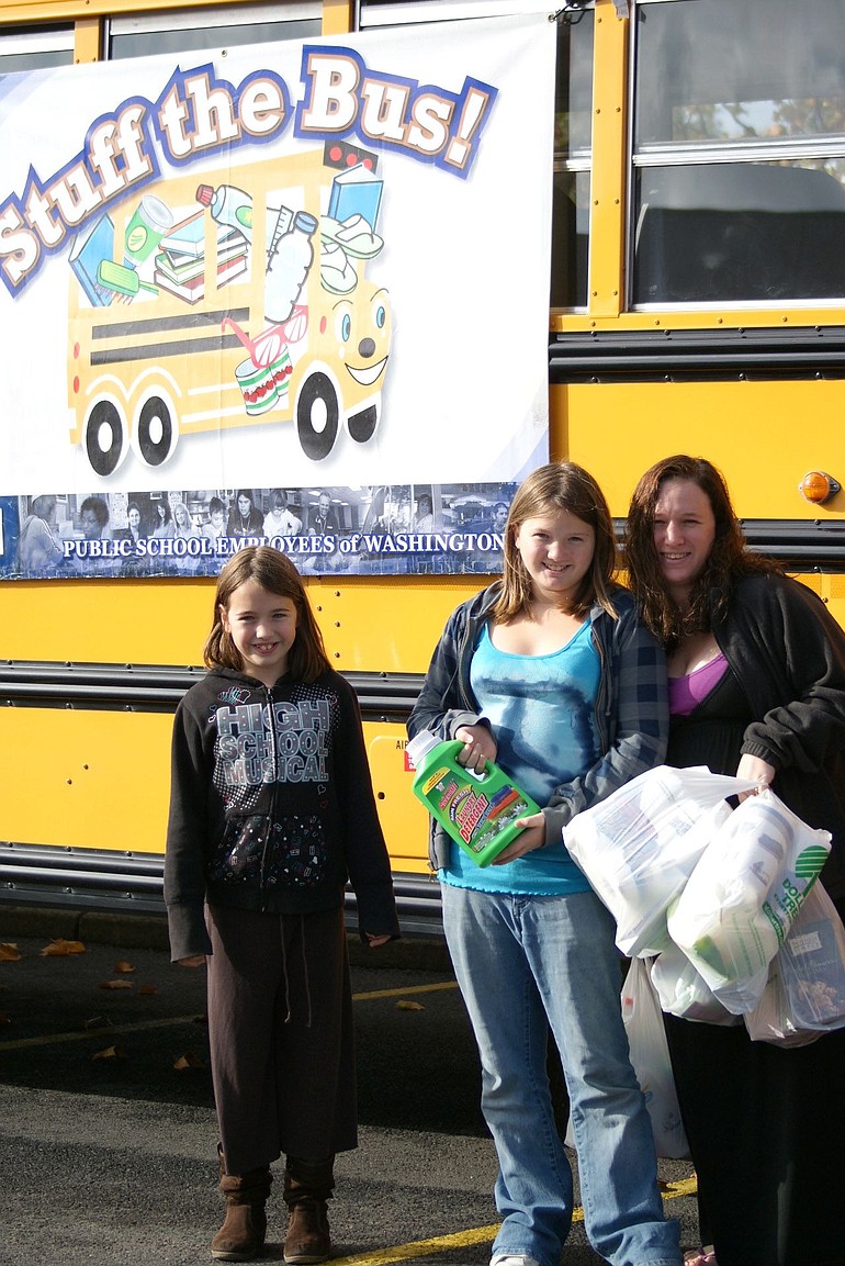 Landover-Sharmel: Megan Vestal, right, and her daughters McKenzie and Madison Day, with donations to the &quot;Stuff the Bus&quot; campaign sponsored by classified employees of Evergreen Public Schools.