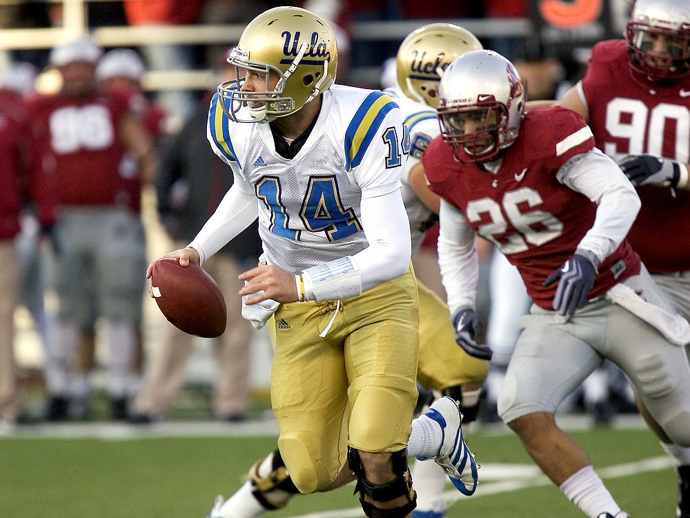 dean hare/The Associated Press
UCLA quarterback Kevin Prince (14) avoids the rush of Washington State's Xavier Hicks.