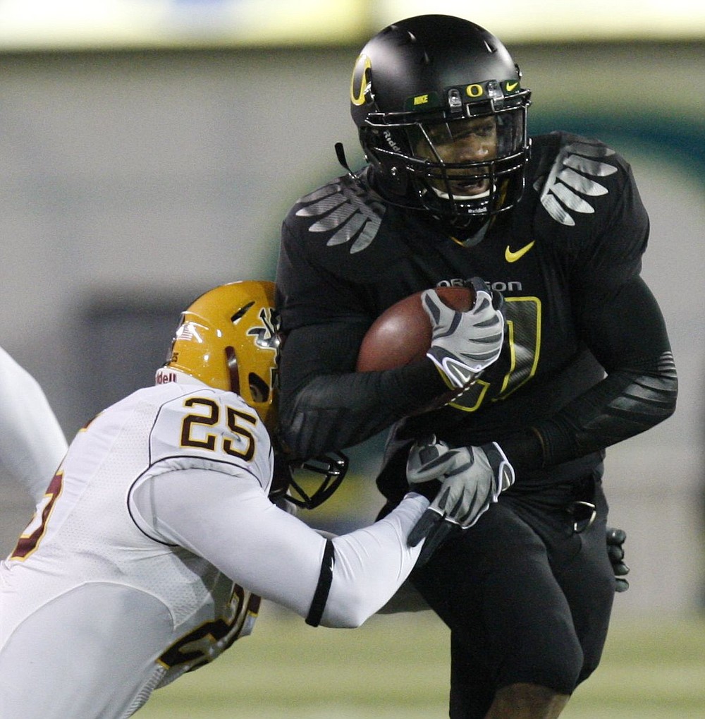 The Associated Press
Oregon's LaMichael James, right, had 150 yards and 3 TDs.