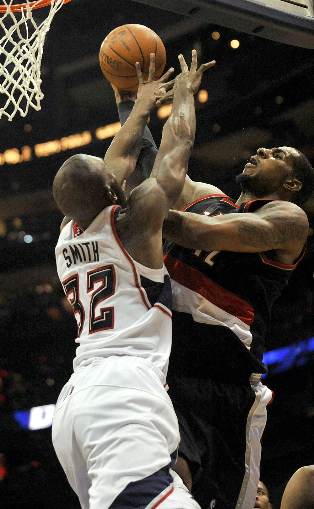 Gregory SmitH/The Associated Press
Atlanta's Joe Smith (32) fouls Trail Blazers forward LaMarcus Aldridge during the Hawks' 99-95 win over Portland on Monday. Aldridge finished with 18 points as the Blazers lost in overtime.