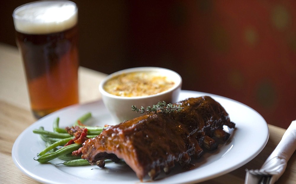 Zachary Kaufman/The Columbian
Laurelwood Public House &amp; Brewery, known for its organic beer, serves Baby Back Ribs doused with Organic Free Range Red BBQ sauce. The ribs come with jalapeno macaroni and cheese and seasonal vegetables at the Battle Ground location.