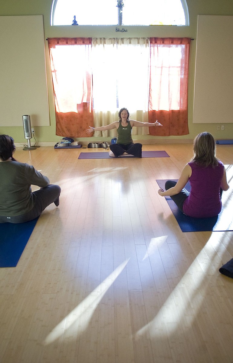 Photos by ZACHARY KAUFMAN/The Columbian
Yoga instructor Jodi Swanson of Vancouver leads a class Nov. 22 as part of a Evergreen4kids fundraiser. Proceeds from the event will benefit the nonprofit group, whose mission is to help impoverished children in the Dominican Republic.