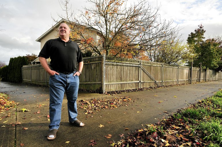 Troy Wayrynen/The Columbian
Norman Brown, an 11-year resident of the area, stands on a pathway behind his home Nov. 17. The path is a notorious hangout for teenage criminals and drug users.