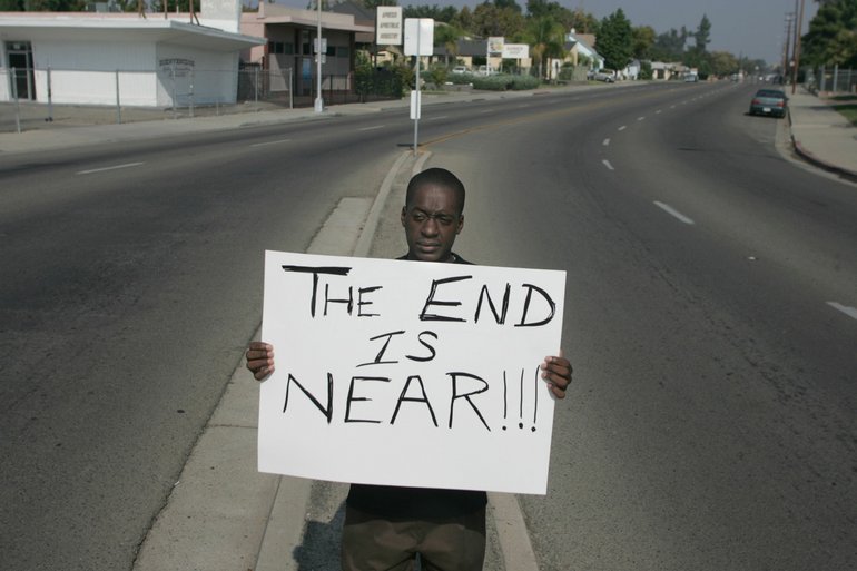 MARK CROSSE/Fresno Bee
Tony Williams of the Aphesis Apostolic Ministry in Fresno, Calif., holds this sign on the weekends to urge people to consider giving their lives to God.