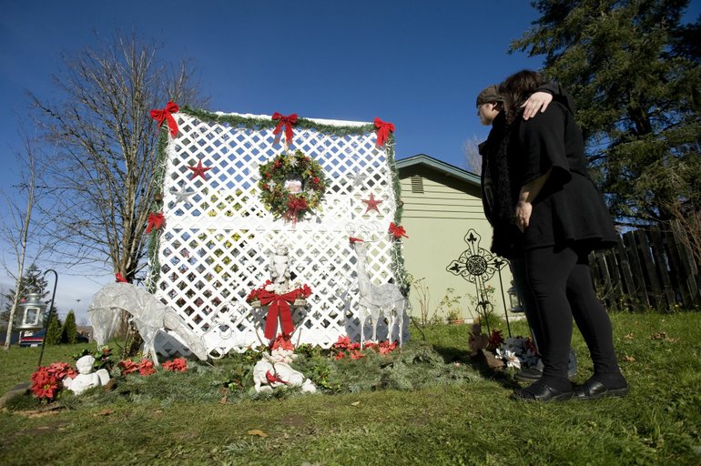 Steven Lane/The Columbian
Valerie Smith, right, and her son Chris Dunn, visit a holiday-themed memorial Tuesday that she created at her home in honor of her late son Curtis Dunn, who was killed seven months ago in Battle Ground. Investigators are continuing to investigate his homicide.