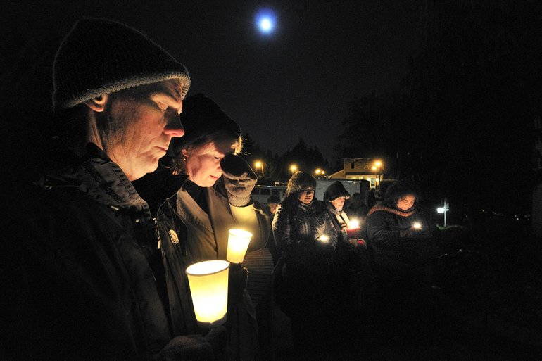 TROY WAYRYNEN/The Columbian 
Terry Ogle, from left, Anne McEnerny-Ogle, Leilani Russell, Brenda Griffith and Josephine Wentzel take part in a candlelight vigil Tuesday night outside Vancouver Police Department headquarters on East Evergreen Boulevard.
