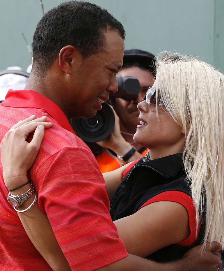 Associated Press files
Tiger Woods and his wife Elin Nordegren embrace after his British Open victory in 2006.