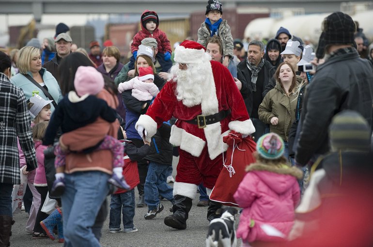 Steven Lane/The Columbian
An enthusiastic crowd greets Santa Claus at the Vancouver Amtrak station Saturday morning. Santa arrived by way of diesel power after the vintage steam locomotive scheduled for the annual Christmas event derailed in Portland.