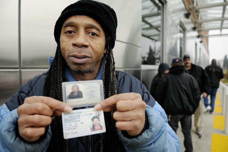 Troy Wayrynen/The Columbian
Ronald Pendleton of Vancouver holds driver's licenses from New Jersey, where he lived several years ago, and Washington to illustrate his previous life of drug addiction and his current life -- seven years clean and sober.