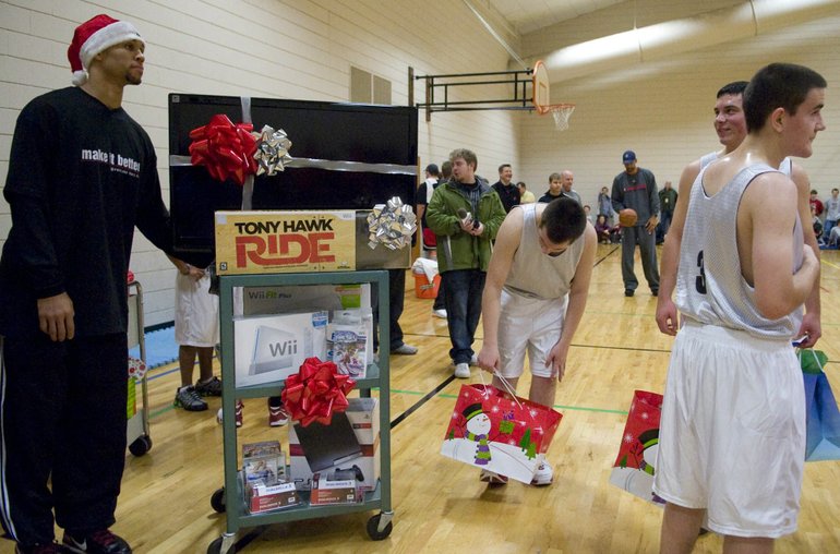 The Blazers Brandon Roy wheels in a cart of gifts that includes a flat screen television, Wii, Playstation III and other assorted goodies during a holiday party and gift exchange at St. Maryis Home for Boys in Beaverton on Wednesday December 16, 2009. The event also included a team practice and scrimmage against the St. Mary's team.