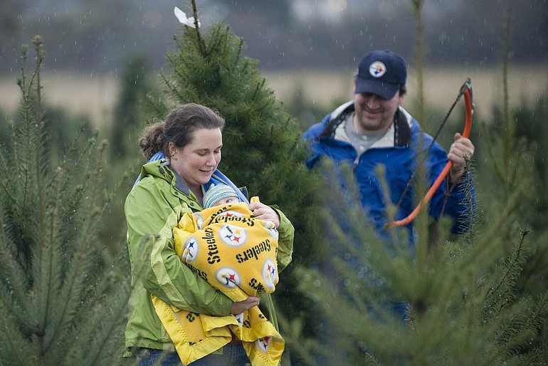The Dubay family, from left, Lauren, Beardyn, 4 months, and Larry, from West Hazel Dell, find the perfect tree for their son's first Christmas.