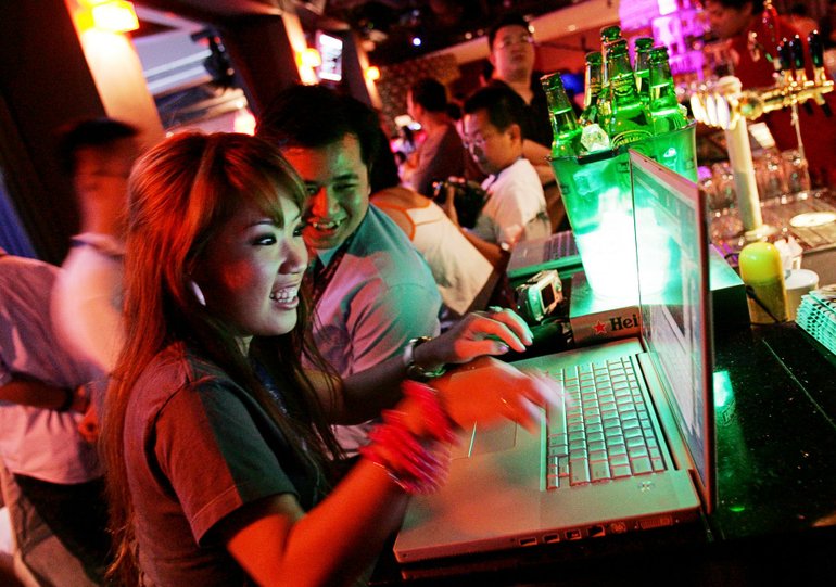 Singaporean blogger Wendy Cheng, who goes by the name Xiaxue when she is online, blogs from the bar at Singapore's first blogging convention July 16, 2005, in Singapore.