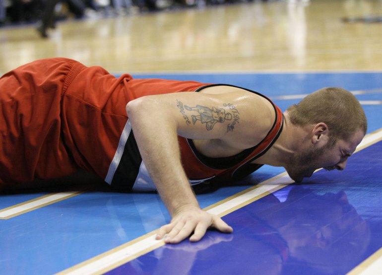 Tony Gutierrez/The Associated Press
Portland Trail Blazers center Joel Przybilla yells out in pain after injury his right knee Tuesday. The injury ended Przybilla's season.