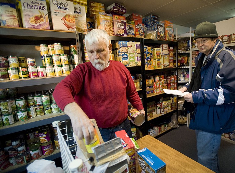 Photos by Steven Lane/The Columbian
Volunteers Jerry West, left, and John Broadbent fill an order at Martha's Pantry.