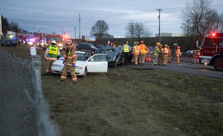 Emergency personnel respond to a fatal accident in the westbound lanes of state Highway 14 near South Grand Boulevard on Saturday.
