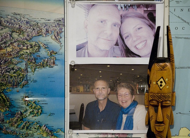 Walt Ratterman is pictured with daughter Briana, top, and wife Jeanne in photos on the wall of his home office.