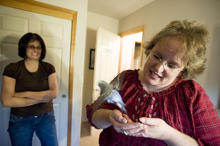 Christa Kangas, right, has learned to read a bird's body language to know when it is in the mood to interact.