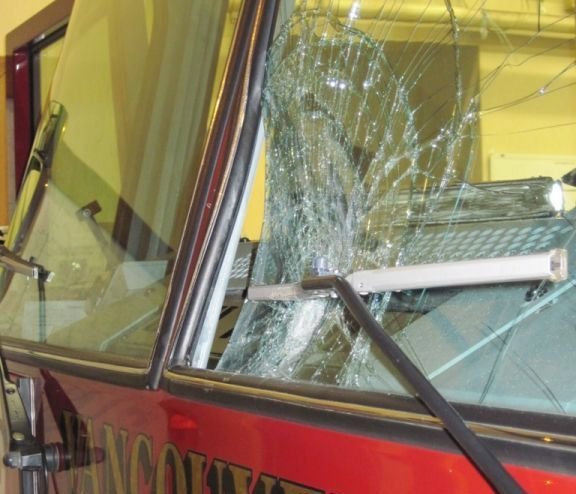 The impact of a large rock caved in part of the driver's-side windshield of one of the Vancouver Fire Department's ladder trucks as it returned from a call in east Vancouver early Saturday.