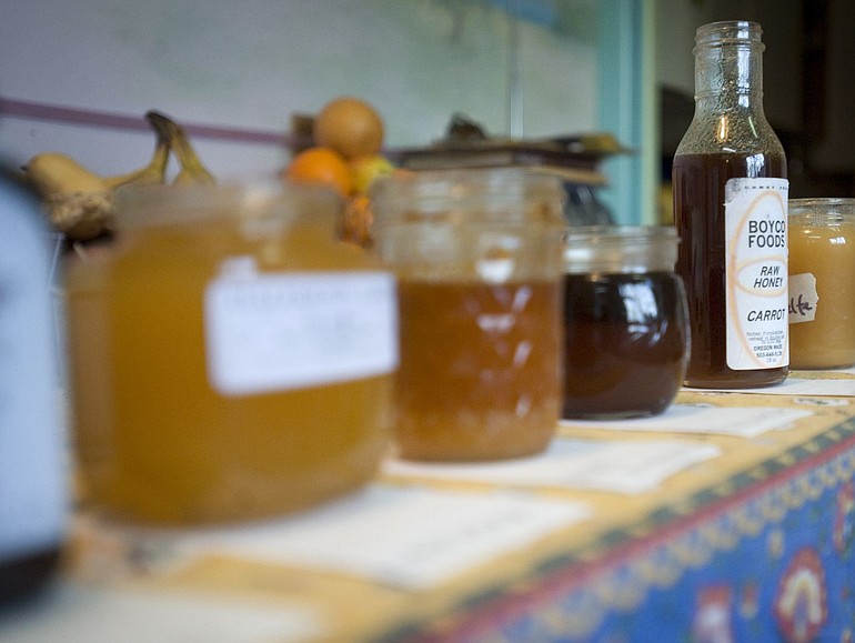 An array of honey produced in hives near different crops sits on a table to be sampled during Jacqueline Freeman's class on bee-friendly beekeeping Saturday.