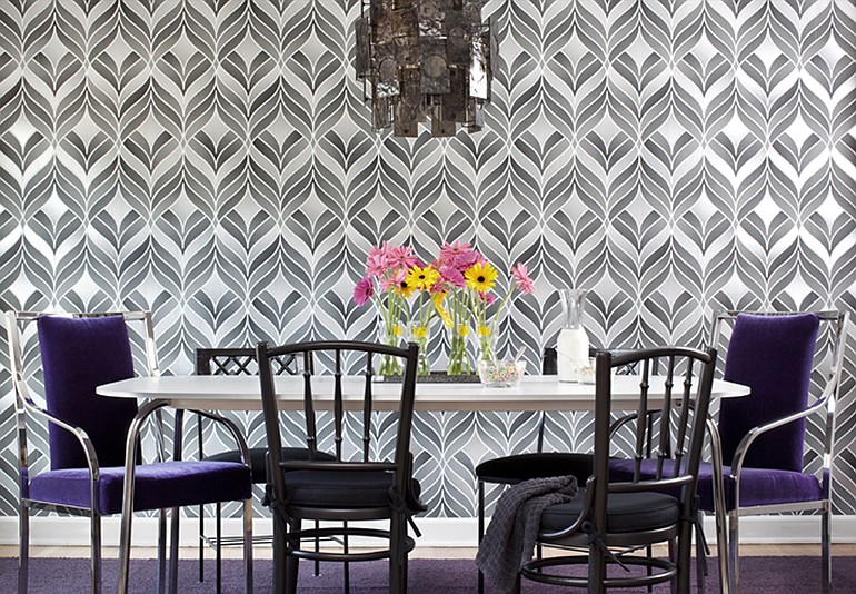 A gender neutral dining room, top right, by Brian Patrick Flynn, uses gray, black and silver wallpaper, a charcoal acrylic chandelier and deep violet mohair upholstery. A master bedroom, left, also by Flynn, features masculine geometric linen pillows and a feminine satin duvet.