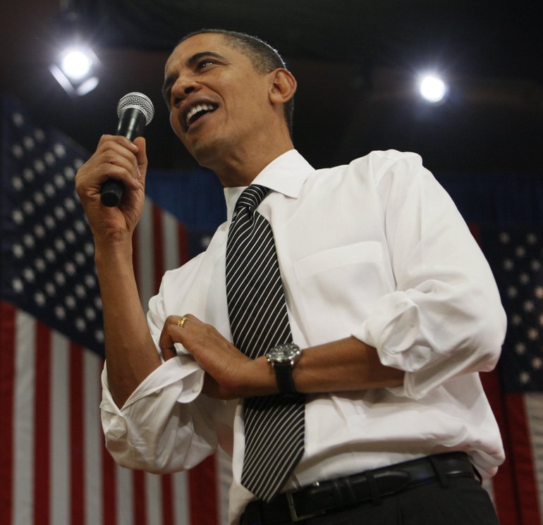 President Barack Obama rolls up his sleeves at a town hall-style meeting Thursday at the University of Tampa in Tampa, Fla., where he announced $8 billion in funding for rail projects.