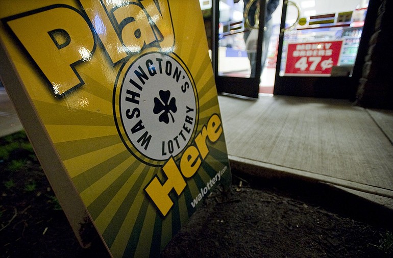 A sign promoting the Washington State Lottery sits outside the downtown Vancouver Plaid Pantry, 514 Washington St., on Sunday.