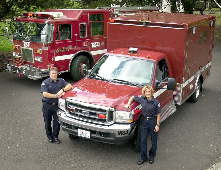 Firefighter/Paramedics Perry LeDoux and Heidi Ferris stand next to the Vancouver Fire Department's medical rescue unit when it was debuted at Station 3 in 2003.