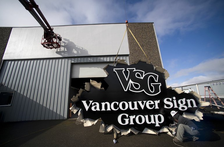 Crews from Vancouver Sign Co. hoisted its parent company's sign above its new, larger Andresen Road headquarters this week.