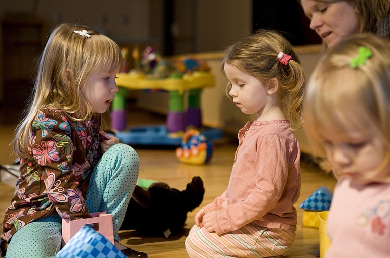 Four-year-old Kira Rilling, from left, plays with 2-year-old Macy Lyons and 2-year-old Natalie Rilling at First United Methodist Church, where a MOMS Club meets during the winter as a way for mothers and children to get out of the house together.