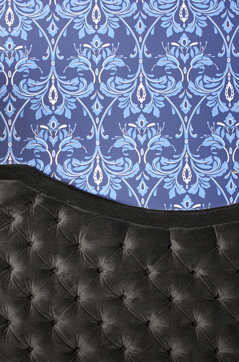 Flynn often adds glamour through diamond-tufted upholstery and ornate wallpapers.