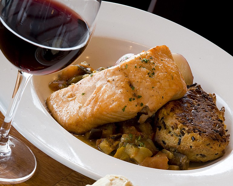 Charlies Bistro in downtown Vancouver puts a twist on traditional dishes, such this Potlatch Steelhead, which is fire-roasted and served with wild rice-corn cake and ratatouille.