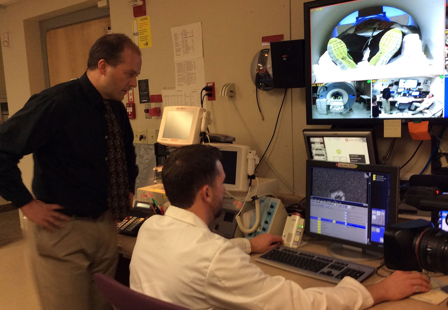 Jeff Anderson, left, and Michael Reading look over images of brain function from Auriel Peterson, a Mormon who volunteered to undergo scanning as part of Anderson's religious brain project at the University of Utah.