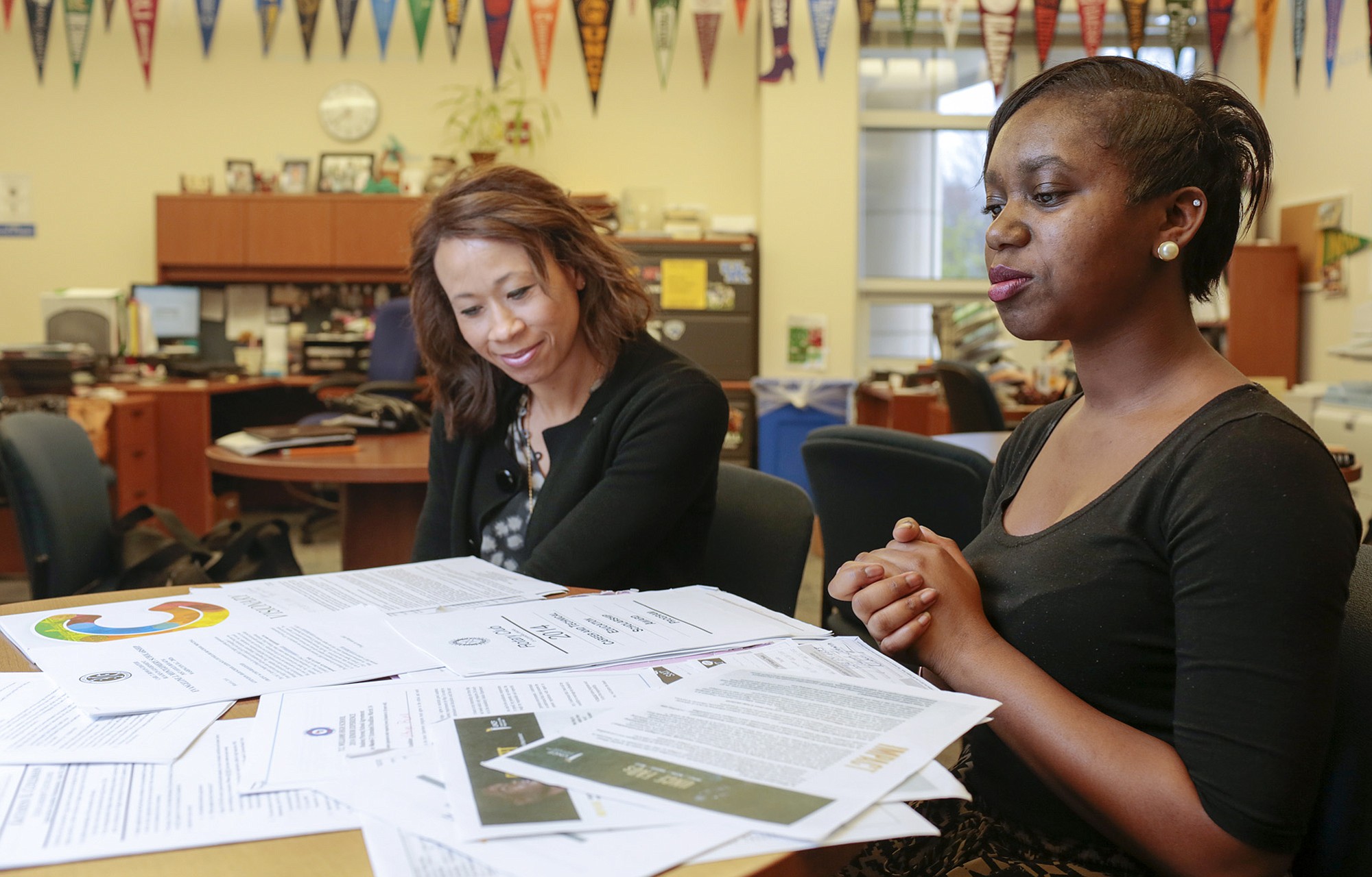Dayna Smith for The Washington Post
Vikaya Powell, 17,  right, confers last year with Patricia Braun, college and career specialist at T.C. Willams High School in Alexandria, Va. For parents with college-bound children, it's time to figure out how much your family can get in financial aid.