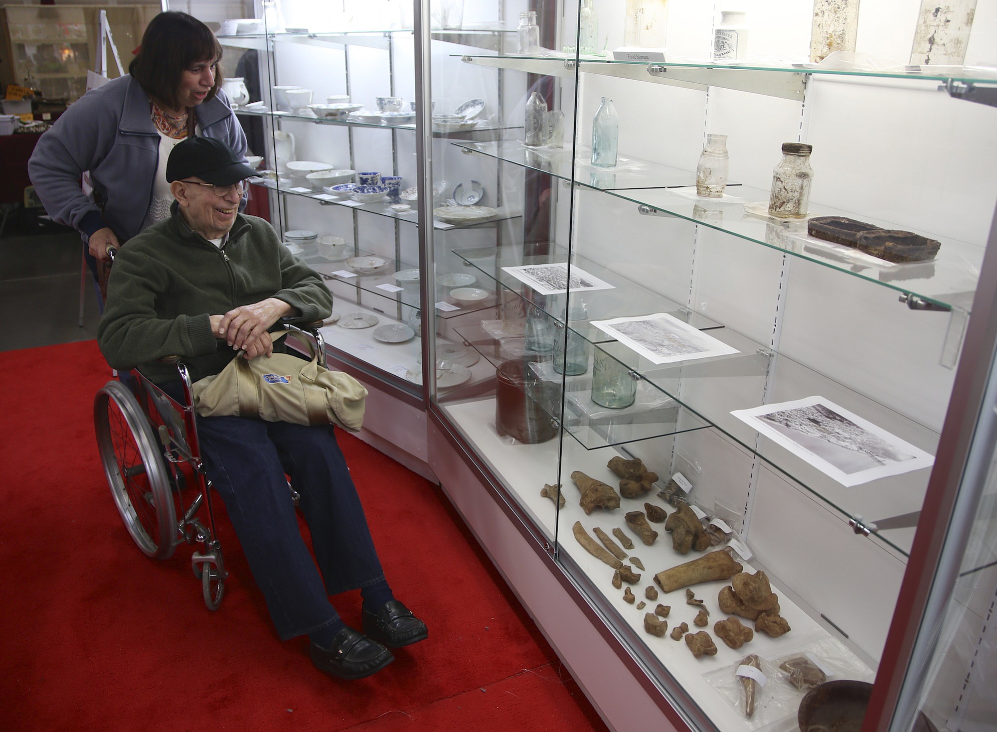 Susan Mulqueen and her father Ralph Marquez look Sunday at artifacts dug up by archaeologists in downtown Vancouver.