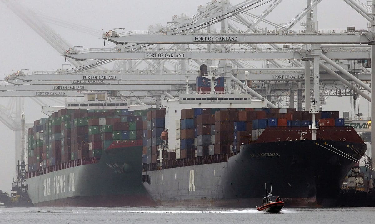 Associated Press files
Container ships wait to be offloaded at the Port of Oakland   in 2013.