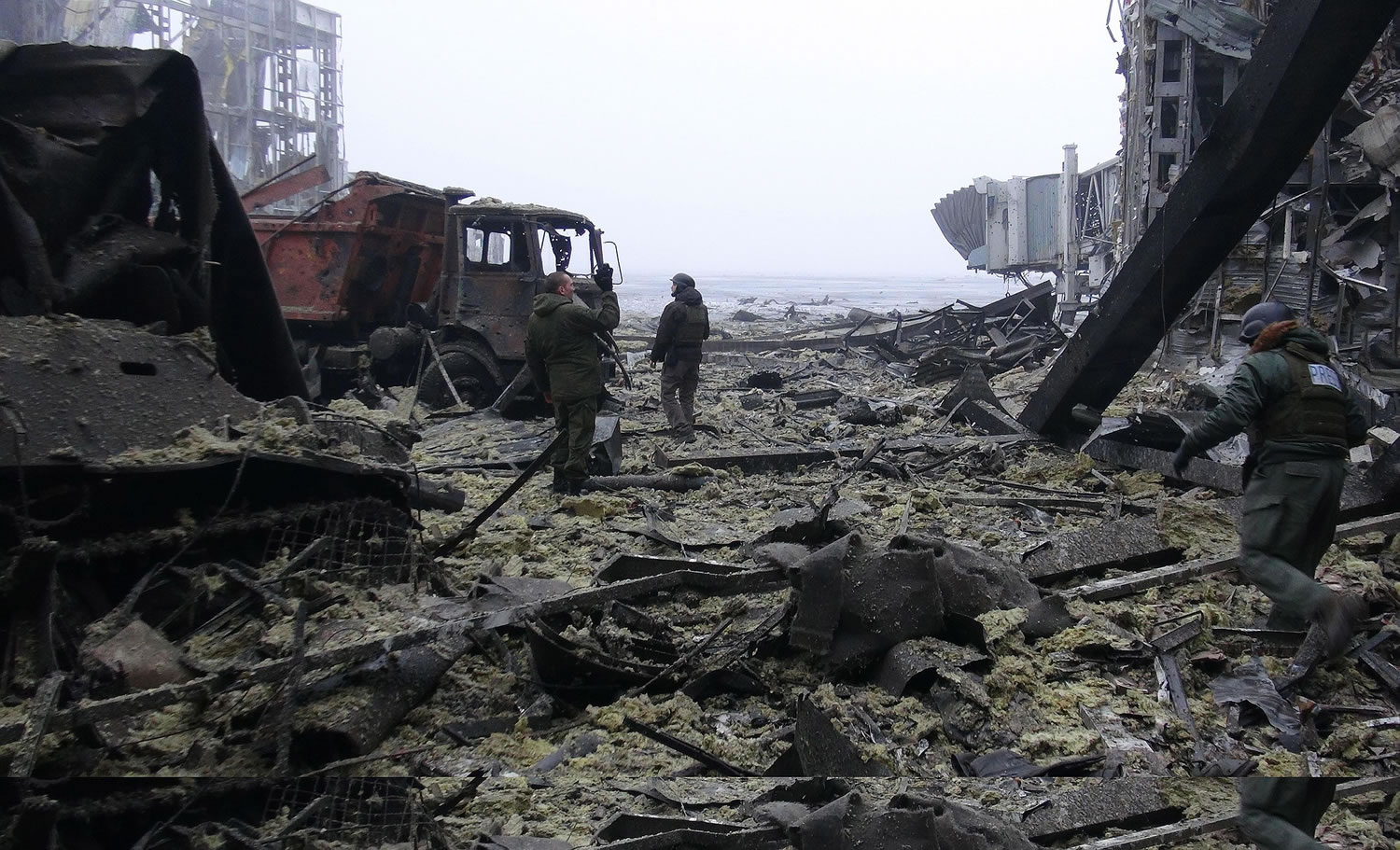 Pro-Russia rebel soldiers clear debris in the destroyed Donetsk Airport on Wednesday in Donetsk, Ukraine.