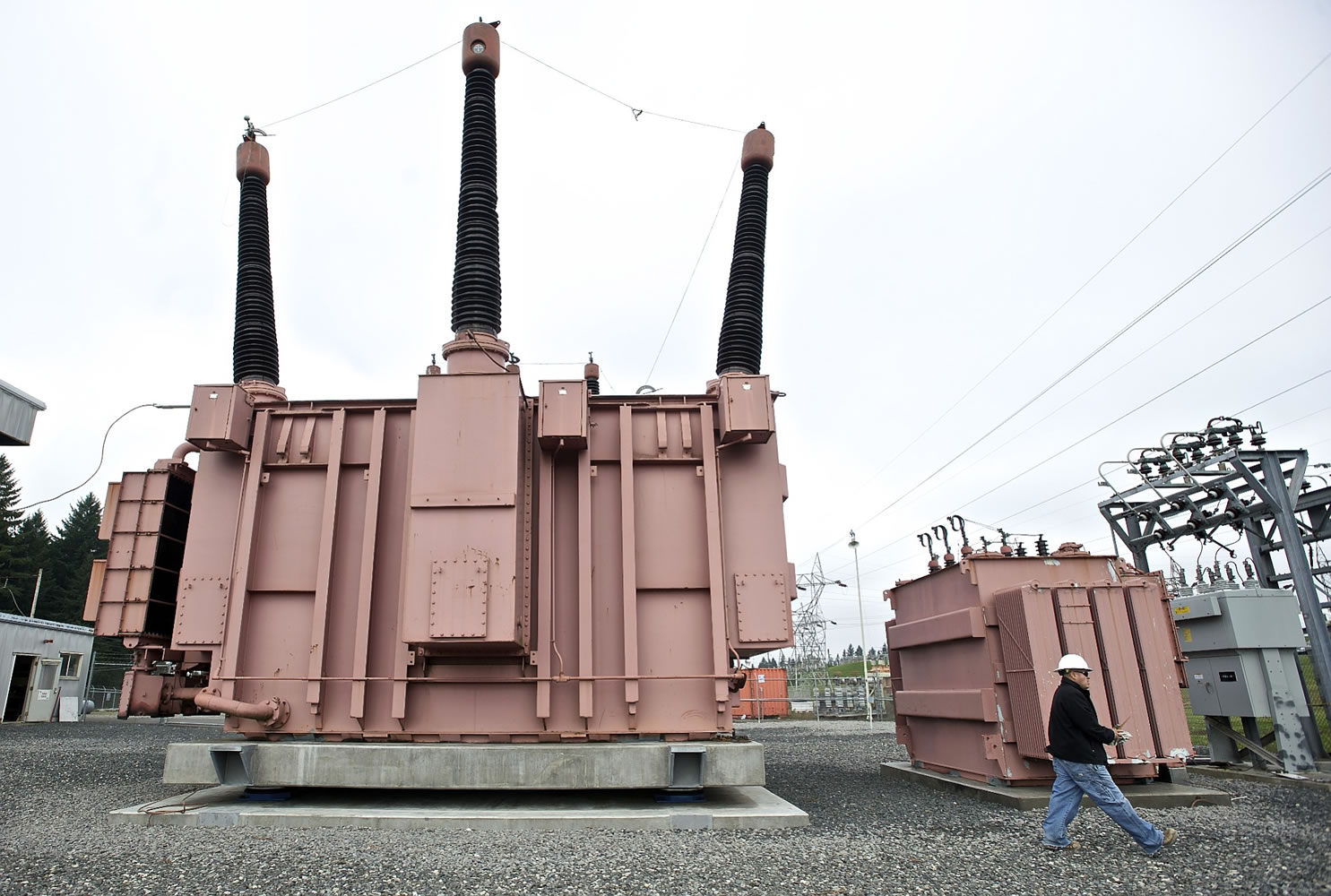 A Bonneville Power Administration civil engineering technician walks past a 400,000-pound transformer, which has been retrofitted with base isolators that will absorb some of the energy during a seismic event.