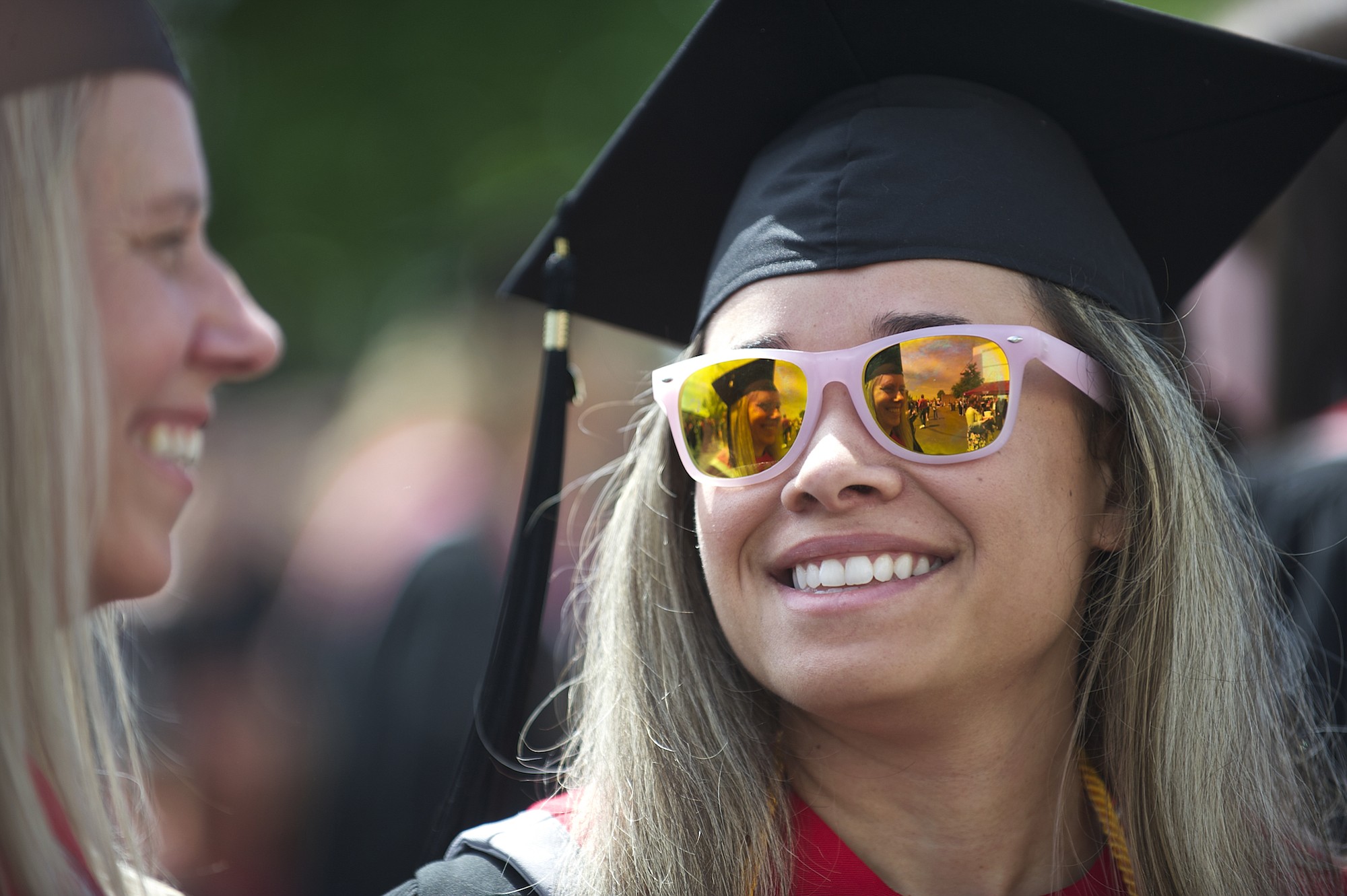 Elizabeth Roe, 27, of Chehalis, looks over at her fellow graduate and mother Jan Roe, 52, before the Washington State University Vancouver's 2013 commencement ceremony.