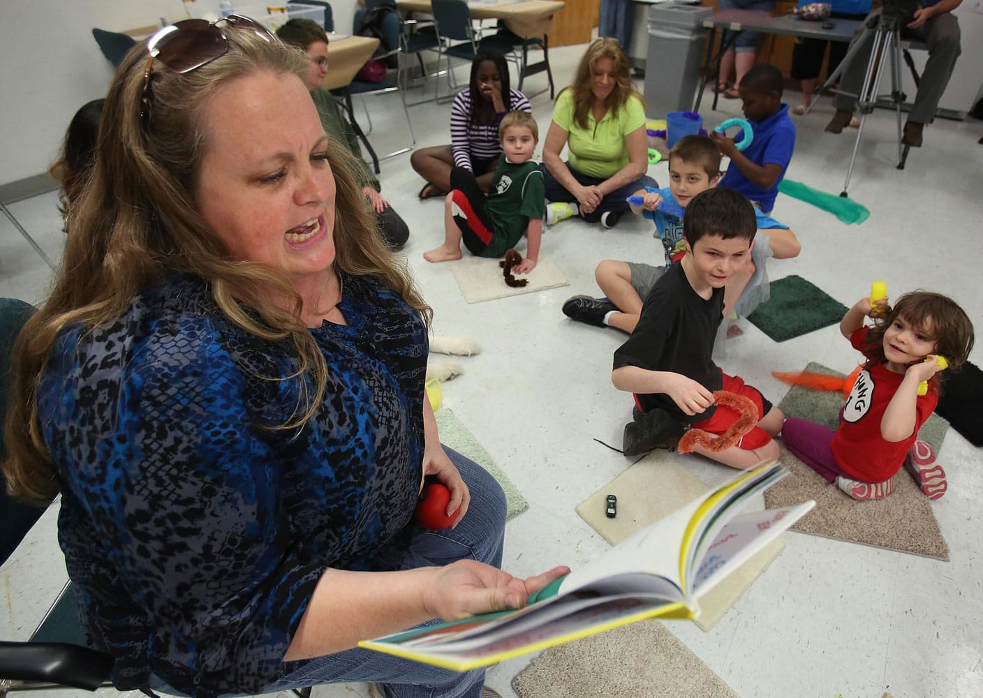 Elizabeth Steele reads to autistic children during an Autism Friendly Storytime event in January at the East Lake County Library in Sorrento, Fla.