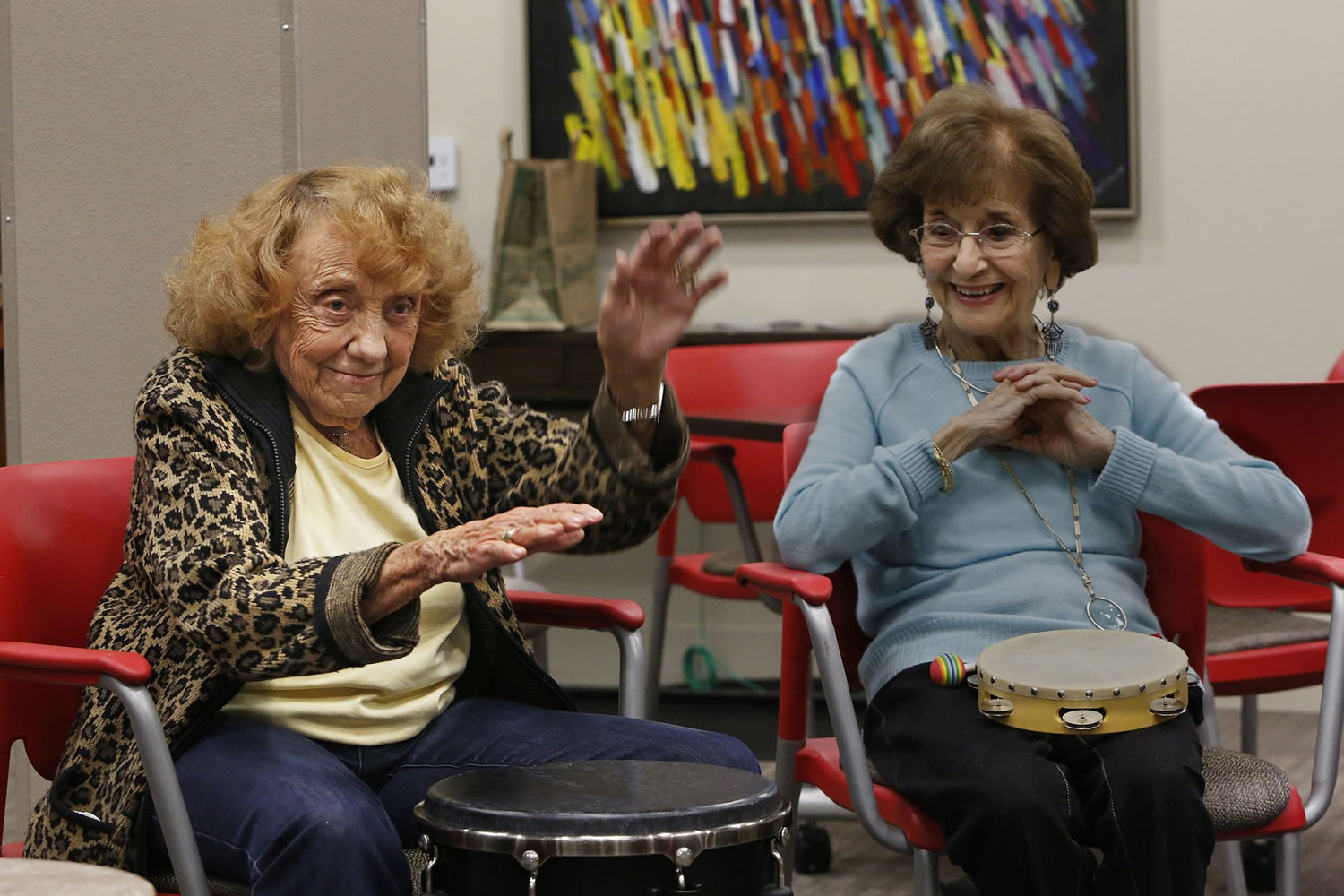 Bert Sanders, left, performs a solo as Mary Shook, right, listens during a drum circle class at the NoHo Senior Arts Colony on Nov.