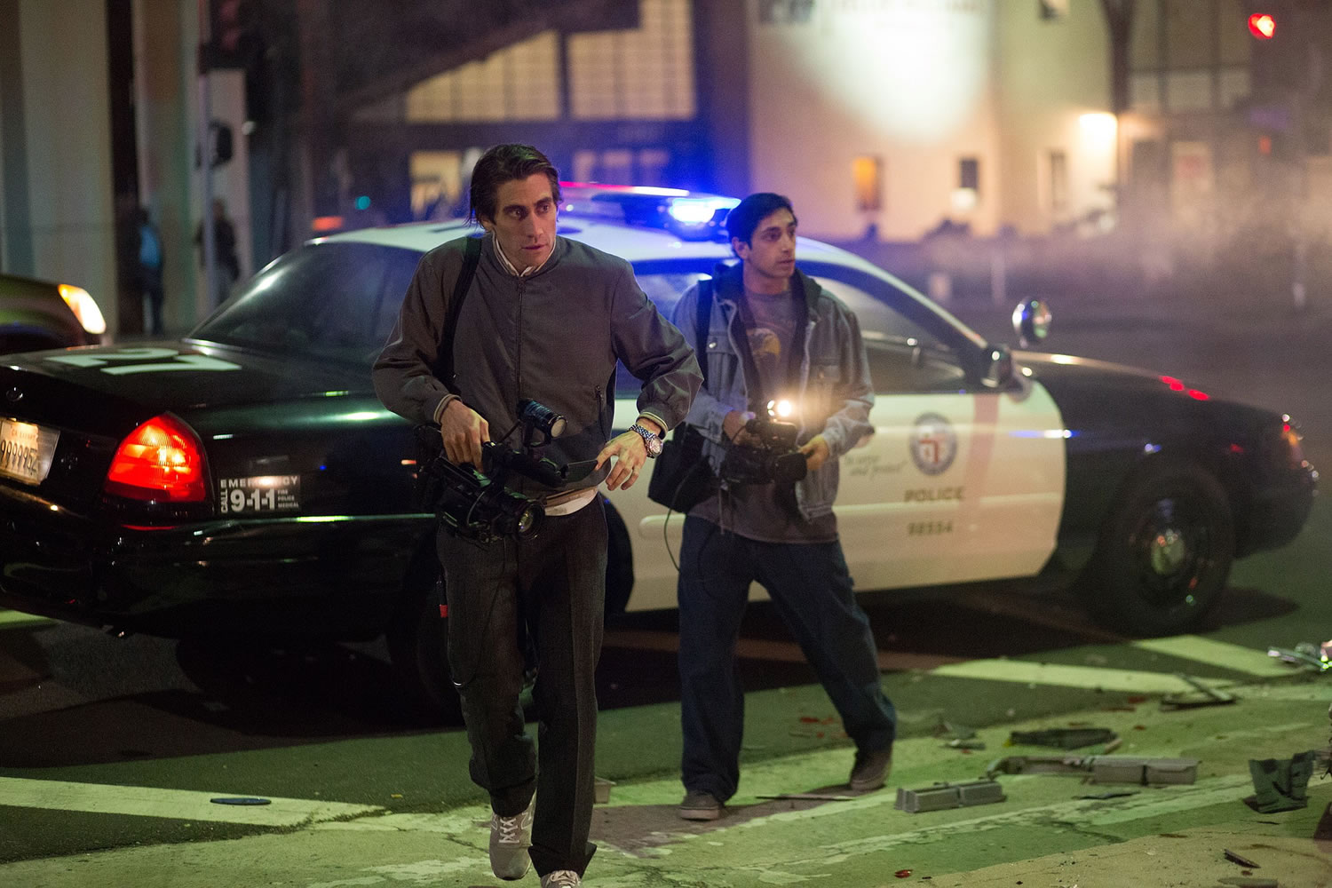 Jake Gyllenhaal, left, and Riz Ahmed check out a crime scene in &quot;Nightcrawler.&quot;
