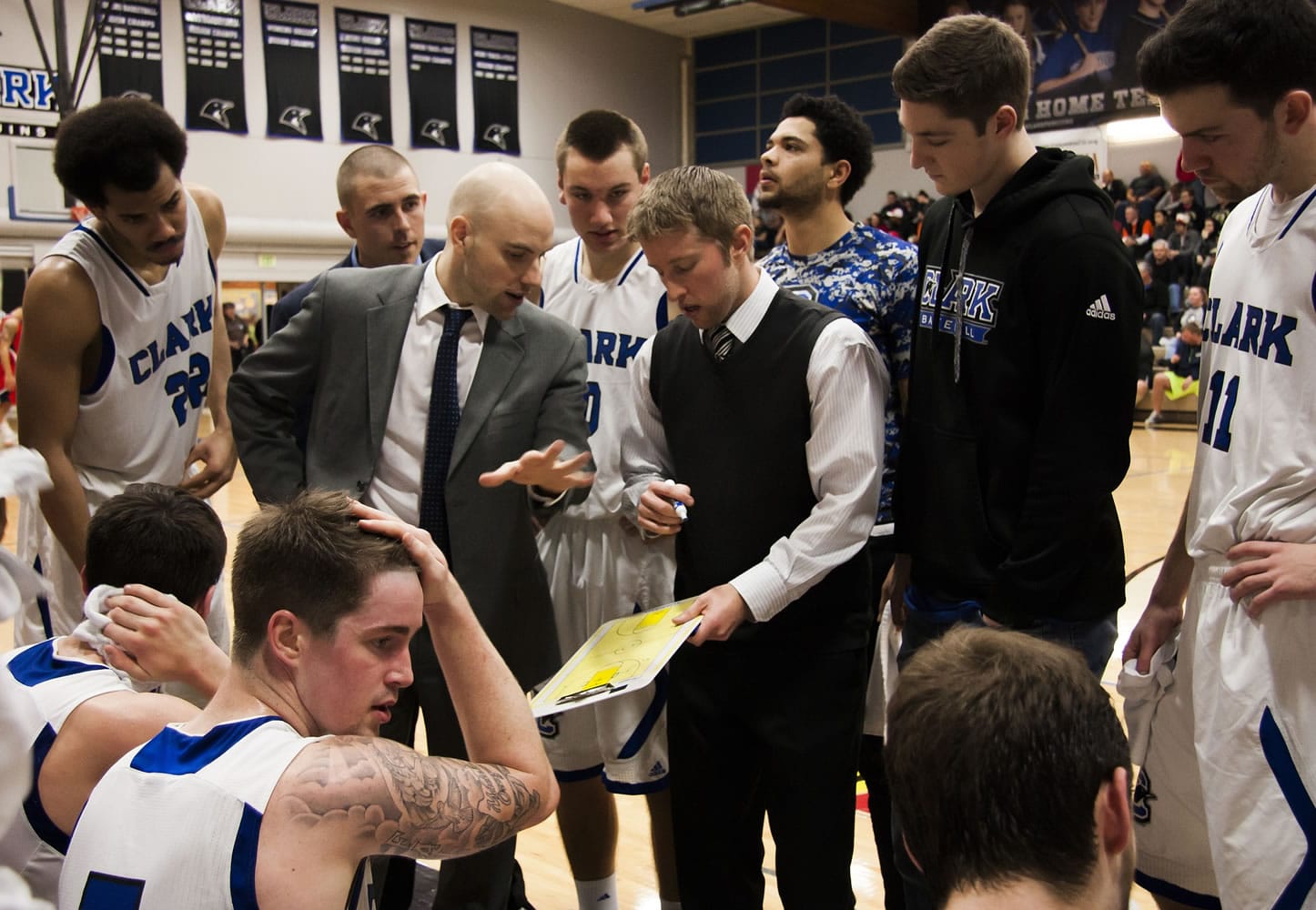 The Clark College men's basketball team huddles during a timeout against Lower Columbia College on Feb.