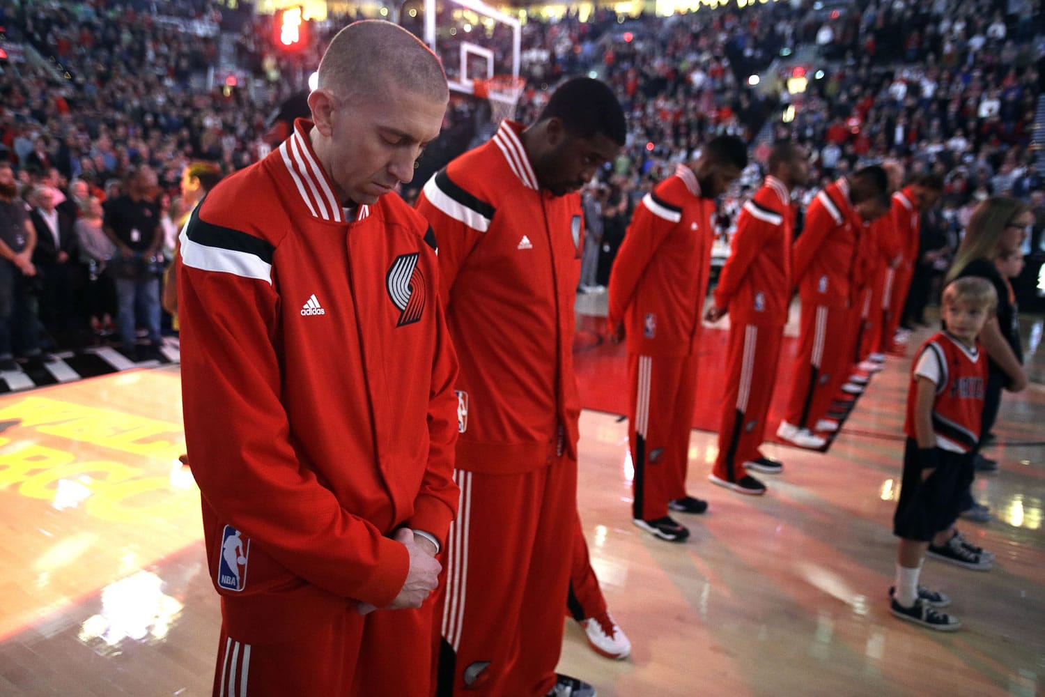 Portland's Steve Blake, left, is joined by his teammates for 25 seconds of silence in memory of former Trail Blazers Jerome Jersey, who passed away suddenly last week at the age of 52.