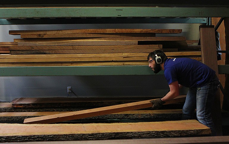Nick Leidenfrost places wood on a drying rack in January at Goebel &amp; Co. Furniture in St.