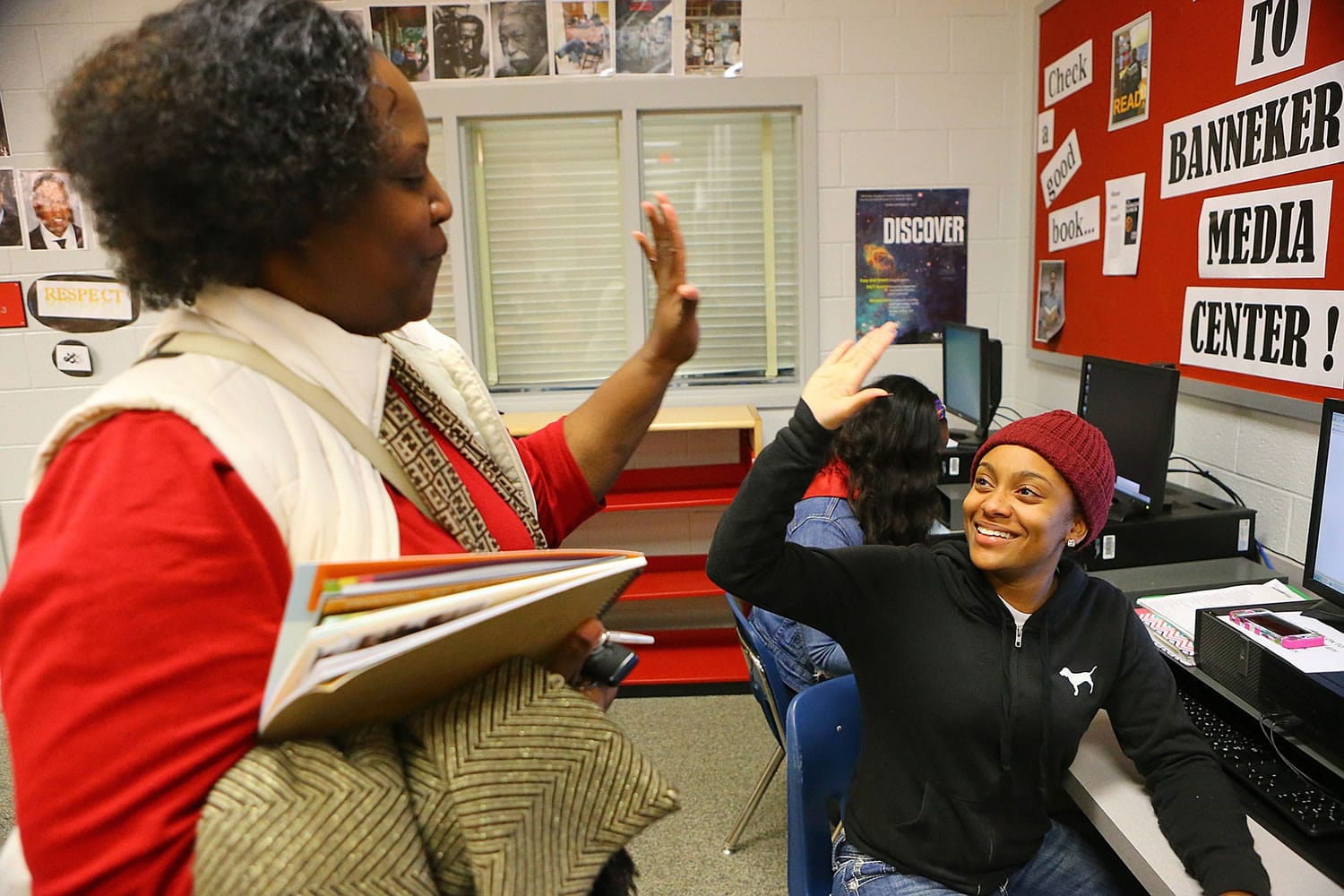 Curtis Compton/Atlanta Journal-Constitution
Glenda Shivers, left, gets a high five from her niece Summer McMath, 18, after helping her complete her financial aid form during a financial aid workshop in College Park, Ga.