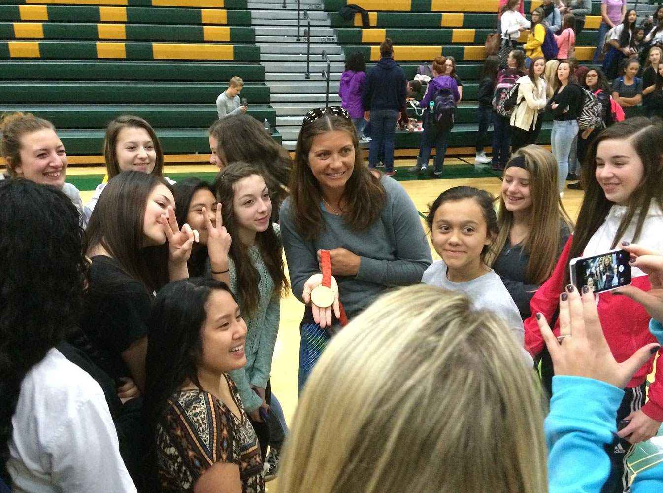 Olympian beach volleyball player Misty May-Treanor shows one of her Olympic gold medals to students at Evergreen High School on Friday.