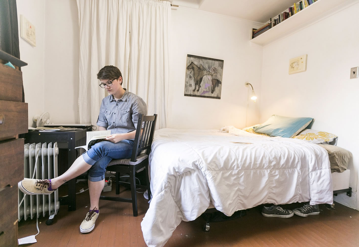 Airbnb guest Megan Walsh, a Chicago writer on a summer internship, reads in her room May 19 at home of artist Jonathan Entler in Los Angeles.