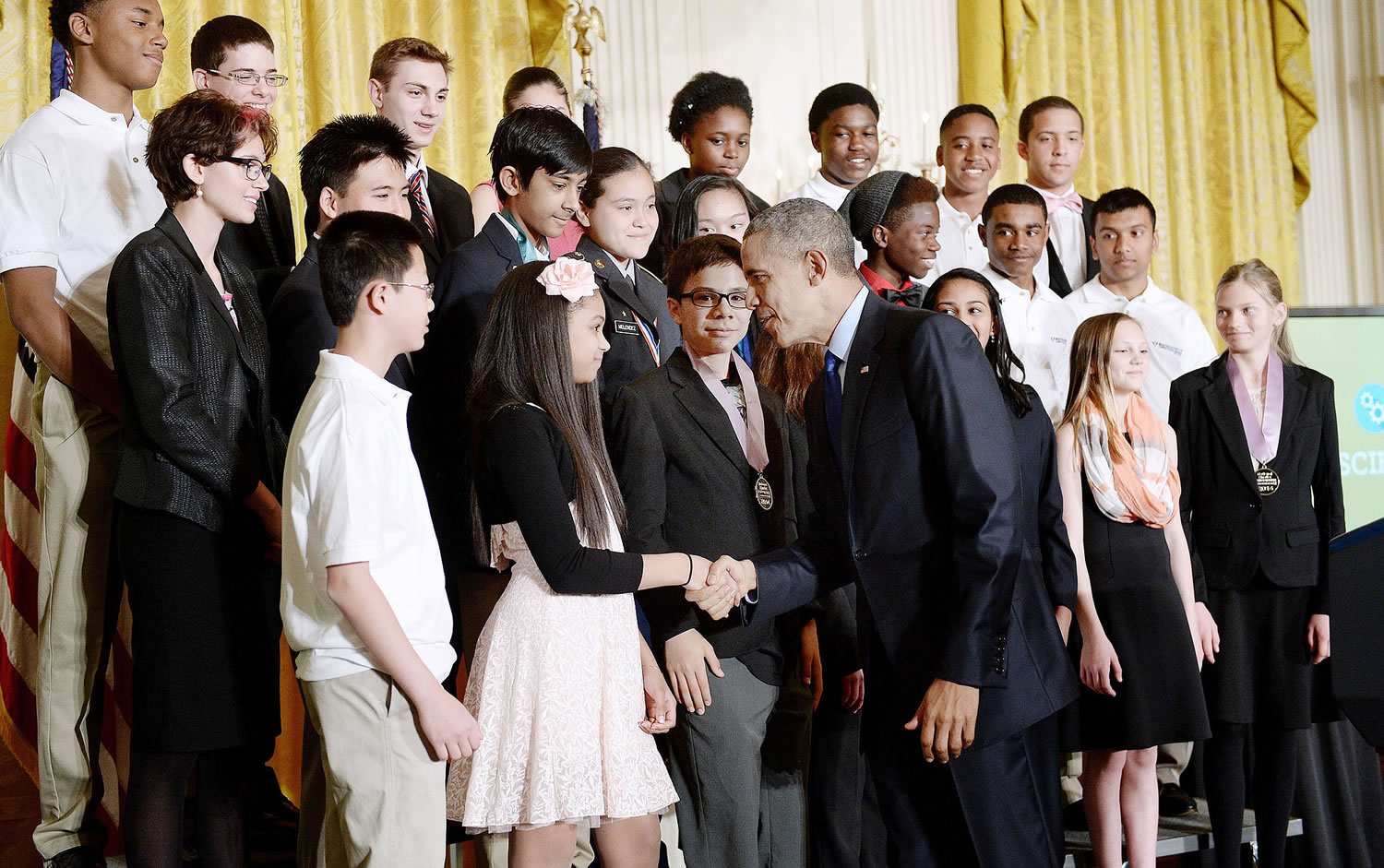 President Barack Obama shakes hands with student winners of a broad range of science, technology, engineering, and math competitions from across the country in the East Room of the White House.