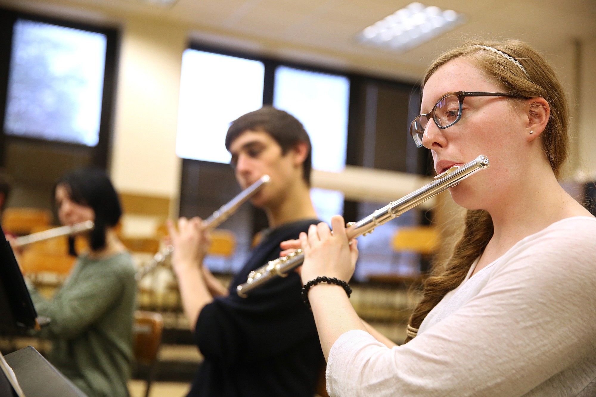Sophia Pellar, 16, plays the flute during a varsity wind ensemble practice at New Trier High School in Winnetka, Ill., on Thursday.